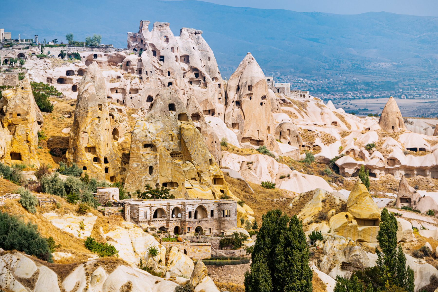 Hotels and houses carved into the rocks of soft volcanic tuff in Cappadocia - one of the wonders of the world in Turkey.